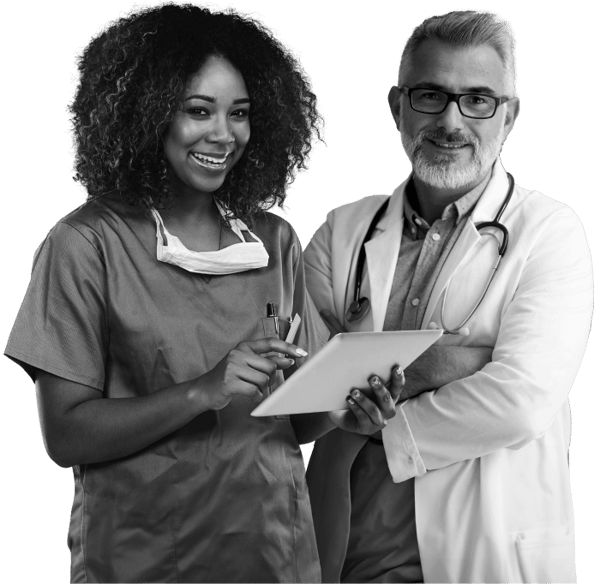 Female doctor holding a tablet with a male doctor behind her. 