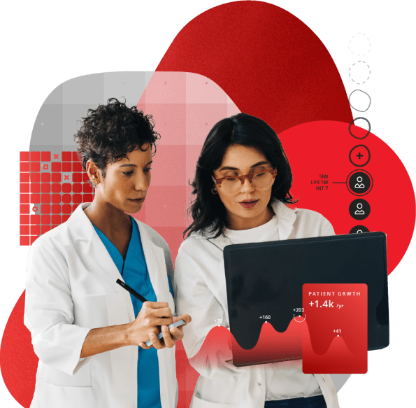Two female doctors looking at a laptop intently.
